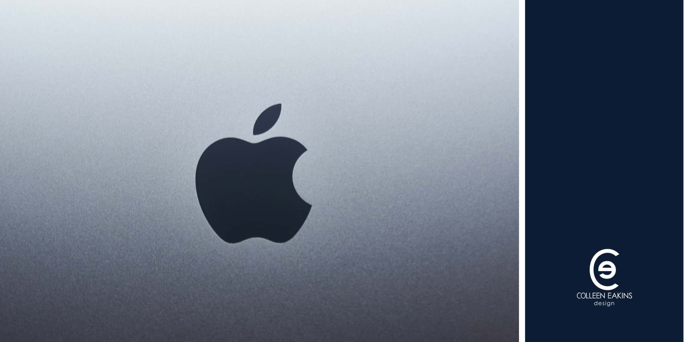 A black Apple logo on a gray surface.